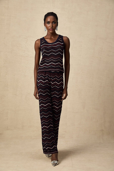 A matching set featuring a zigzag woven crochet knit top and trousers named Emmanuelle The set has a bohemian style with intricate texture and pattern