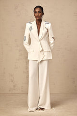 A matching white blazer and trouser set with butterfly appliques embellished throughout the garment