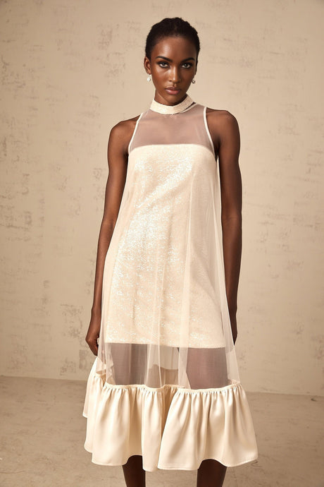 A midi dress with a layered tulle panel and sequin embellishments featuring a combination of sheer and sparkly elements in an elegant silhouette