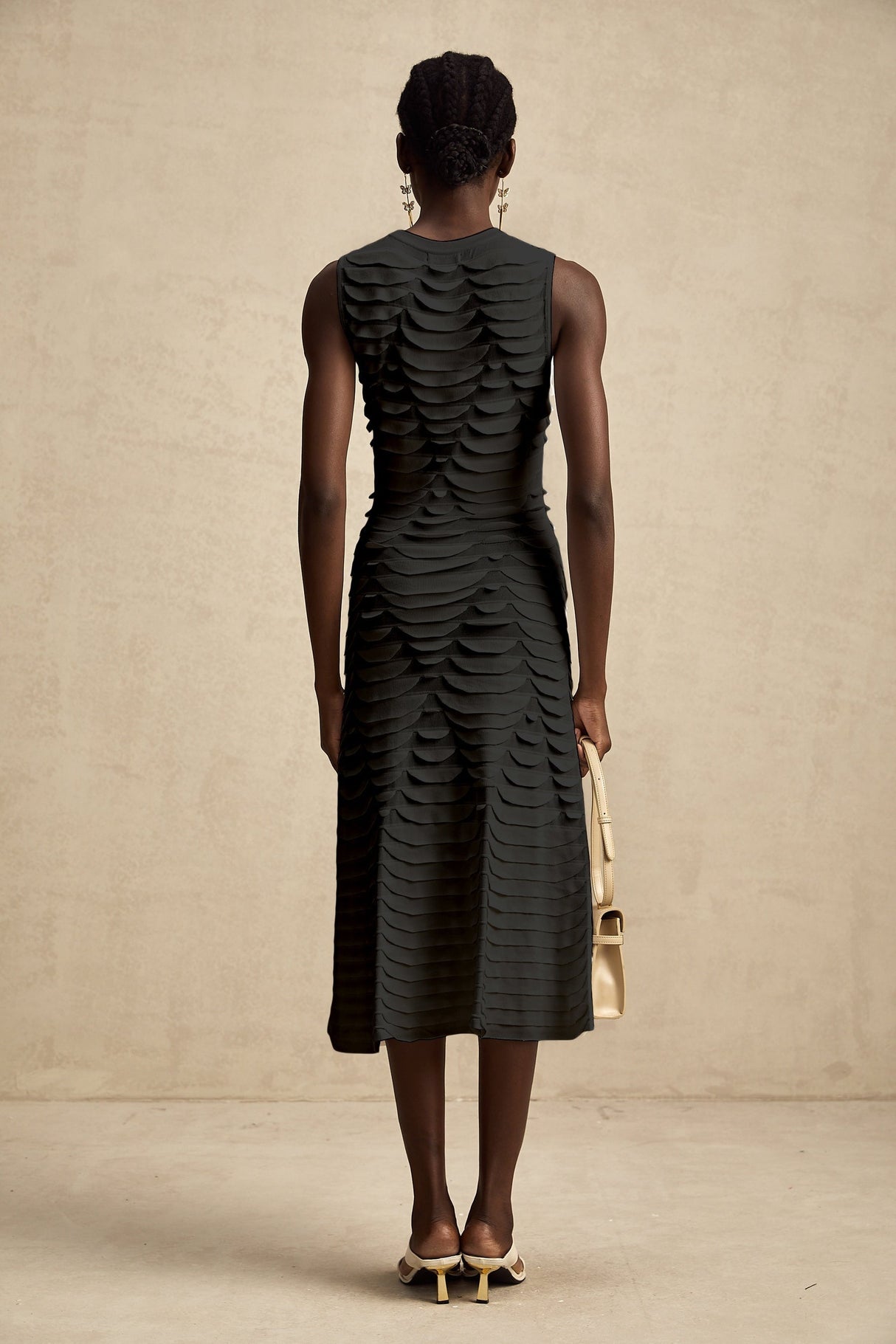 A midi dress with a snake pattern design and godet inserts for added flare