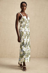 A midi dress with floral embroidery and hollow carved details featuring a delicate Carla design pattern