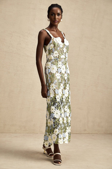 A midi dress with floral embroidery and hollow carved details featuring a delicate Carla design pattern