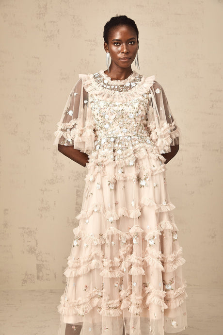 A midi length dress with tiered ruffles and floral embroidery details featuring a delicate pattern and feminine silhouette
