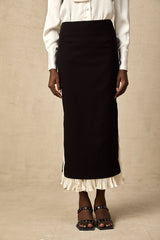 A midi length skirt with color blocked panels featuring the name Heloise