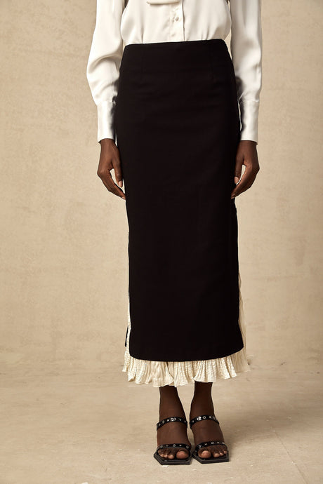 A midi length skirt with color blocked panels featuring the name Heloise