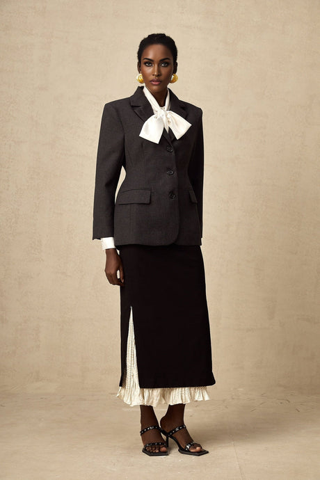 A midi skirt with colorblocked panels featuring the name Heloise