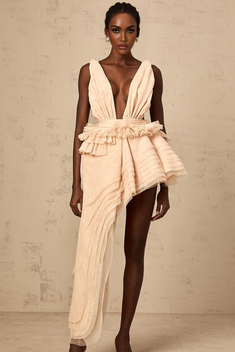 A neutral colored mini dress with an asymmetric hemline featuring a ribbon design pattern across the fabric
