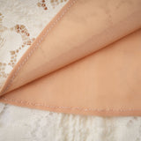 A neutral colored mini dress with floral lace pattern and flared cuffs called Emeline