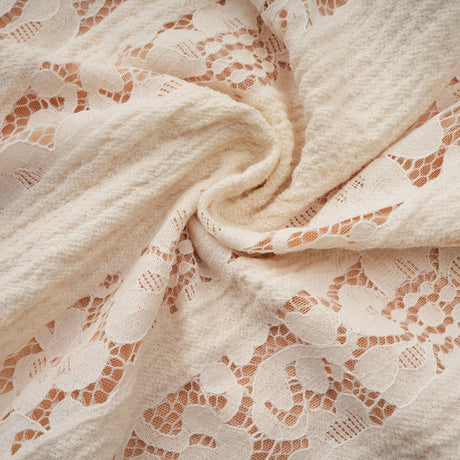A neutral colored mini dress with floral lace pattern and flared cuffs named Émeline