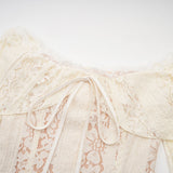 A neutral colored mini dress with floral lace pattern and flared cuffs named Émeline