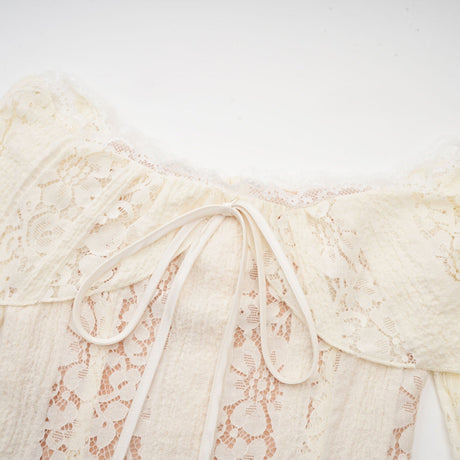 A neutral colored mini dress with floral lace pattern and flared cuffs named Émeline