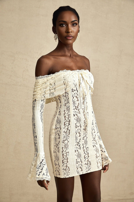 A neutral colored mini dress with floral lace pattern and flared cuffs named Émeline