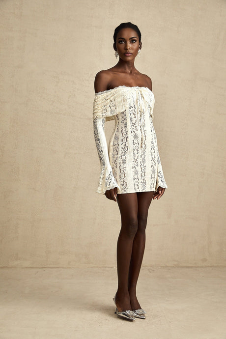 A neutral colored mini dress with floral lace pattern and flared cuffs named Émeline