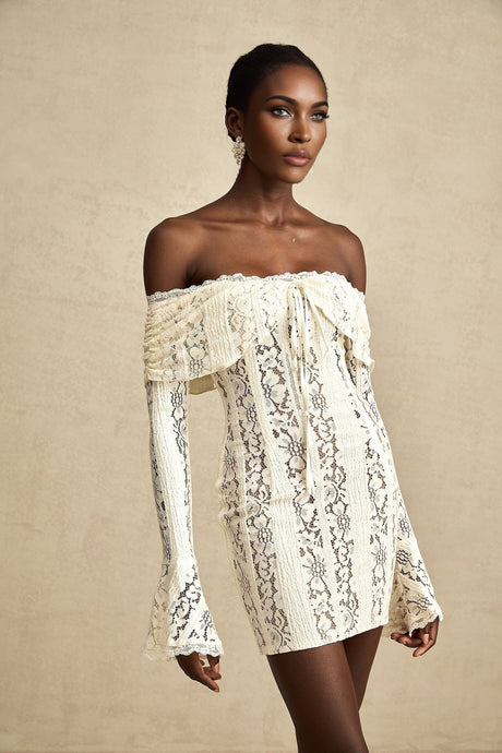 A neutral colored mini dress with floral lace pattern and flared cuffs named Emeline