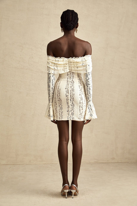 A neutral colored mini dress with floral lace pattern and flared cuffs named Émeline