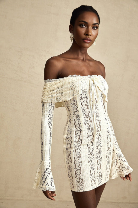 A neutral colored mini dress with floral lace pattern and flared cuffs named Émeline
