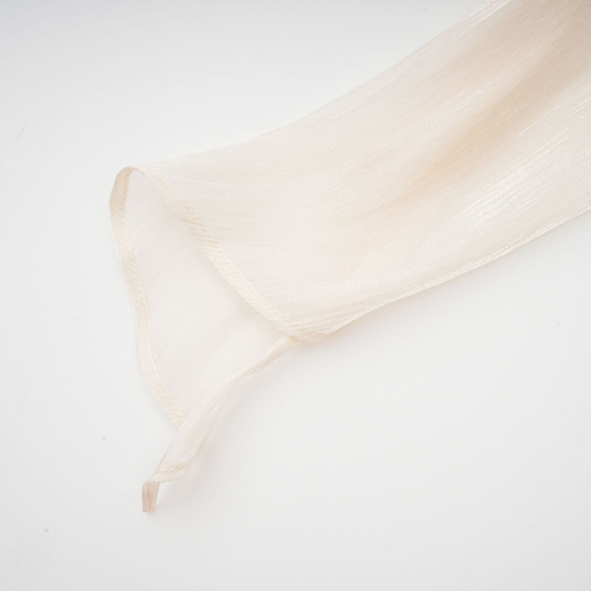 A neutral colored mini dress with full pleats and ruffles named Eugenie featuring a short hemline and feminine design