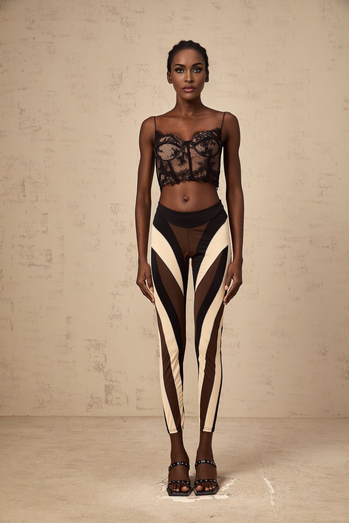 A pair of womens leggings featuring a spiral color block design with multiple colored panels in a swirling pattern