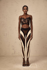 A pair of womens leggings featuring a spiral color block design with multiple colored panels in a swirling pattern