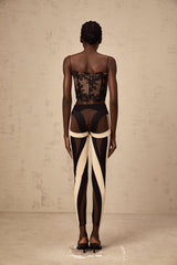 A pair of womens leggings featuring a spiral color block design with multiple panels in contrasting colors