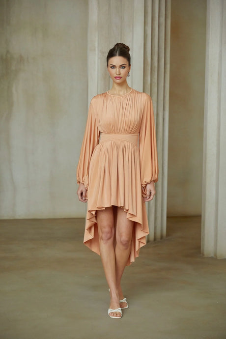 A pink asymmetrical midi dress with pleated details featuring a sleeveless design and fitted waist