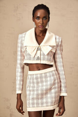 A pink checked tweed jacket and matching skirt set featuring a classic design with a feminine touch