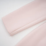 A pink crystal midi dress with colorblocked design featuring the name Anais
