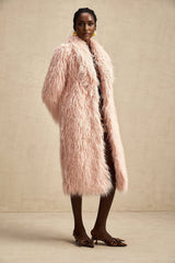 A pink faux fur coat with an open front design modeled by a woman