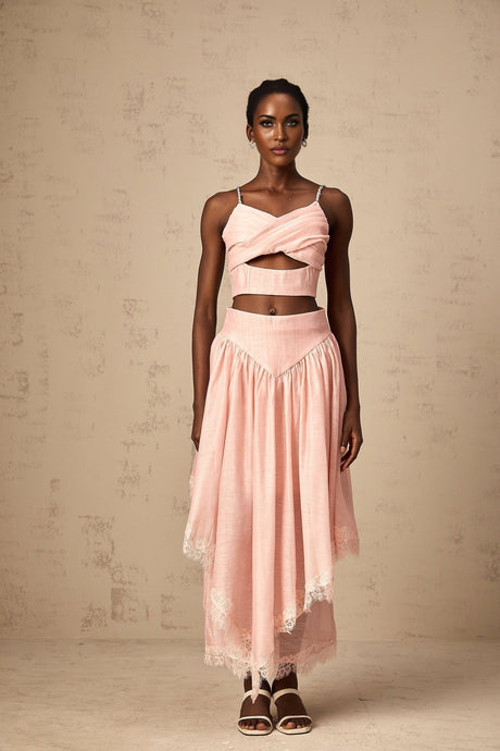 A pink matching set consisting of an asymmetric ruffled top and skirt Both pieces feature a feminine design with Tamara style The top has an uneven hemline with ruffles while the skirt complements the look