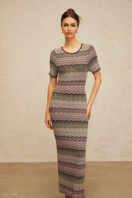 A pink maxi dress with a wavy crochet knit pattern and long sleeves
