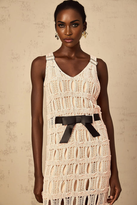 A pink midi dress with a crochet knit pattern featuring a decorative bowknot detail