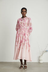 A pink midi dress with a floral print pattern featuring the name Yvette