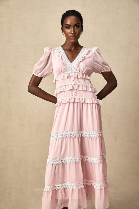 A pink midi dress with a ruffled tiered skirt and Amelie style design