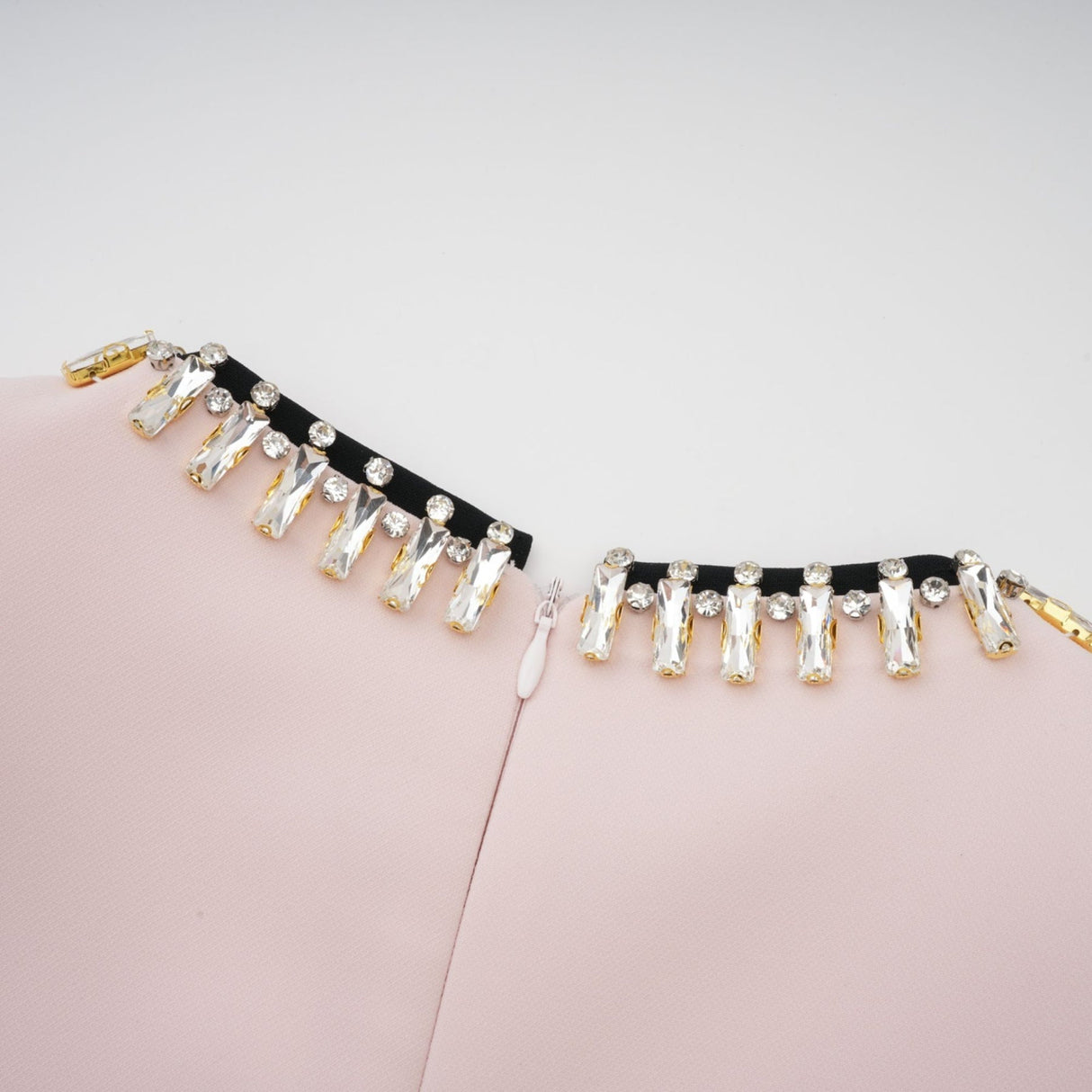 A pink midi dress with crystal embellishments and colorblocked design featuring the name Anais