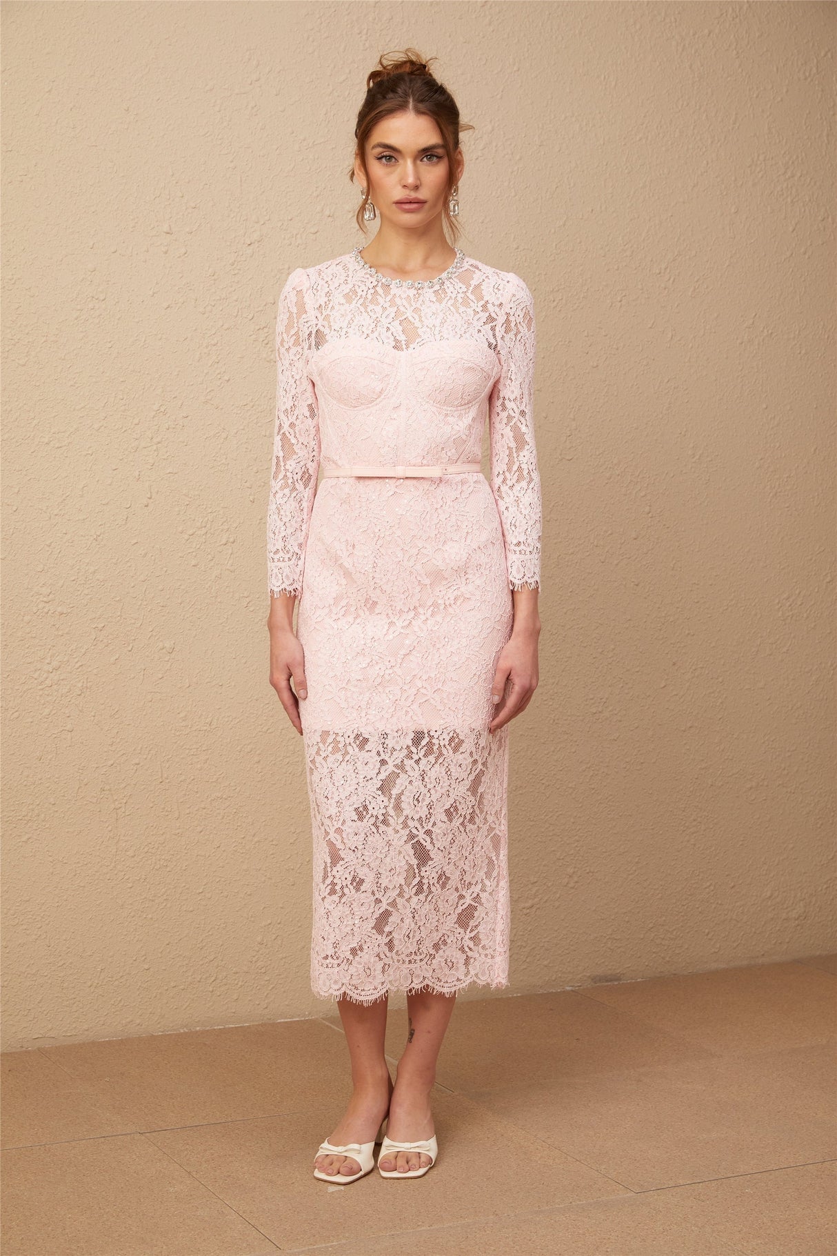 A pink midi dress with floral embroidery and lace details featuring embellishments and a delicate feminine design