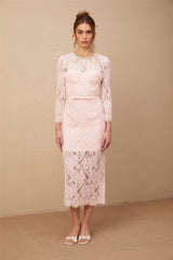 A pink midi dress with floral embroidery and lace details featuring embellishments and a delicate feminine design