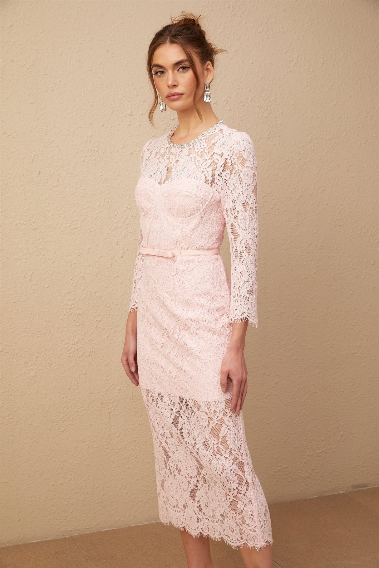 A pink midi dress with floral embroidery and lace details featuring embellishments and a delicate feminine design
