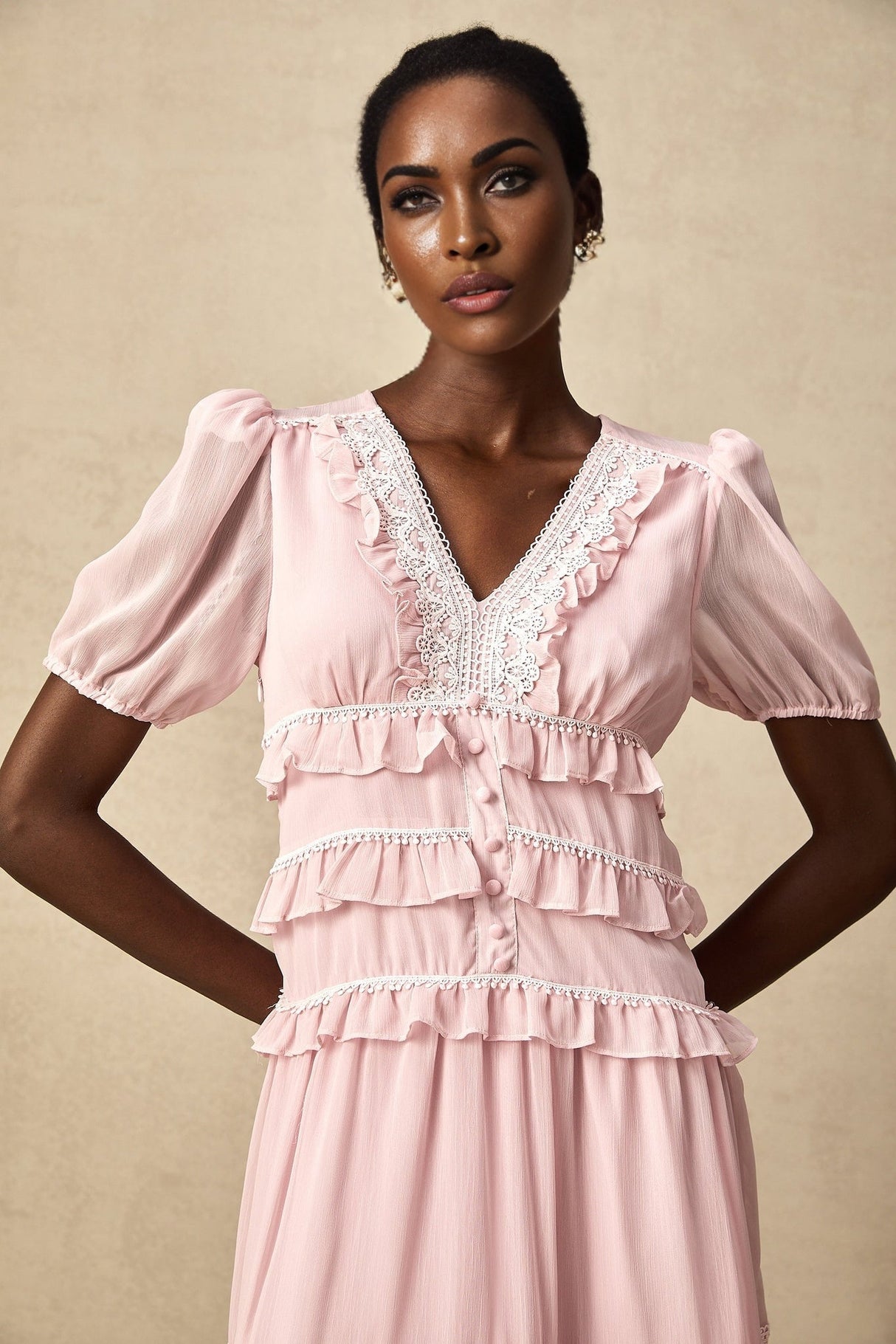 A pink midi dress with ruffled tiers and a feminine silhouette named Amelie