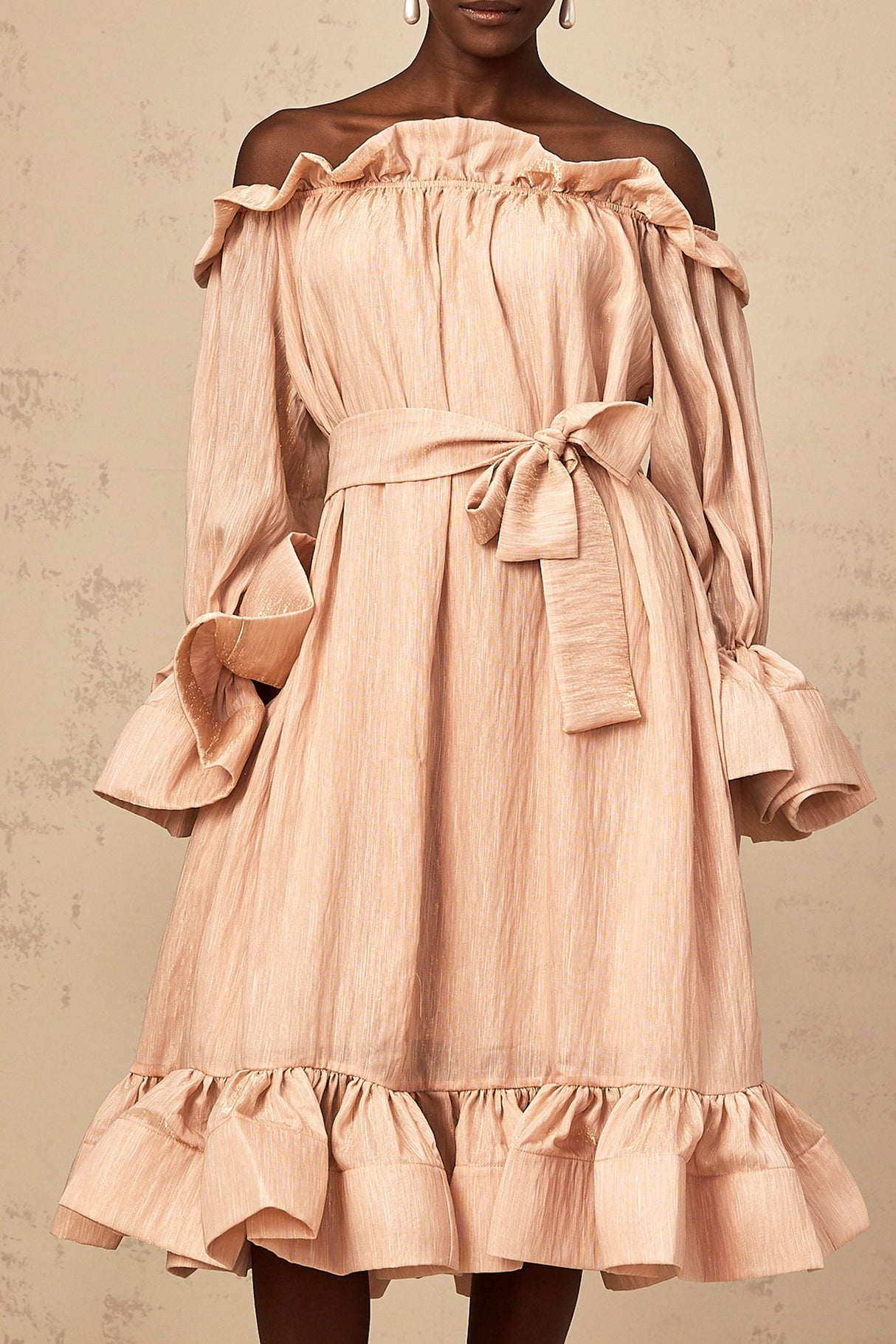A pink midi dress with ruffles and a tied waist detail named Agathe