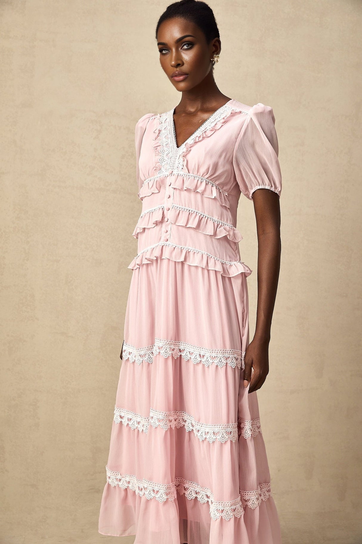 A pink midi dress with tiered ruffles and a feminine Amelie style