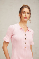 A pink mini dress with a flared skirt and fine knit fabric featuring long sleeves and a fitted bodice