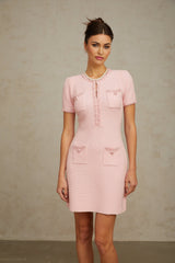 A pink mini dress with a knit texture and beaded embellishments