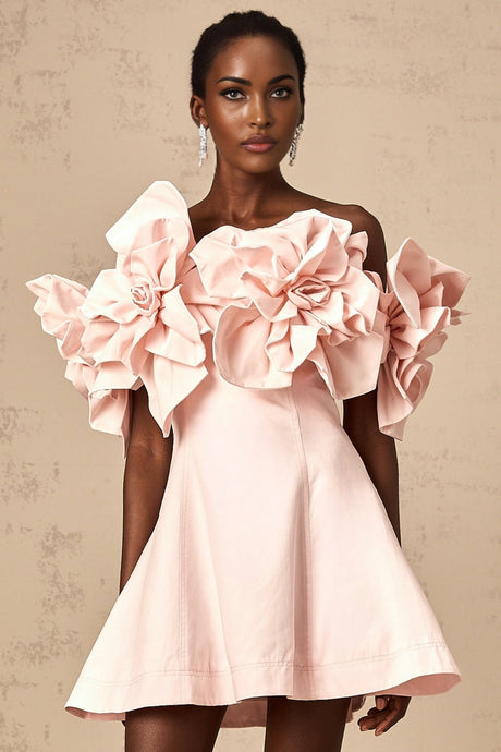 A pink mini dress with an offshoulder neckline featuring three dimensional floral petal details along the bodice named Juliette