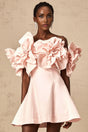 A pink mini dress with an offshoulder neckline featuring three dimensional floral petal details along the bodice named Juliette