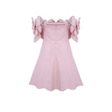 A pink mini dress with an offshoulder neckline featuring three dimensional floral petal details named Juliette