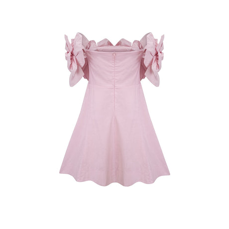 A pink mini dress with an offshoulder neckline featuring three dimensional floral petal details named Juliette
