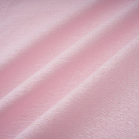 A pink mini dress with an offshoulder neckline featuring three dimensional petal details and a short hemline