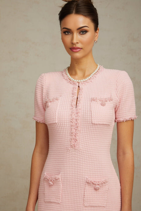 A pink mini dress with beaded embellishments and a knit texture featuring a short hemline and feminine design