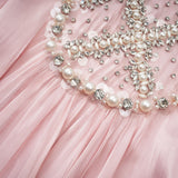 A pink mini dress with embellishments and pleated design named Helena