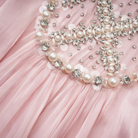 A pink mini dress with embellishments and pleated design named Helena